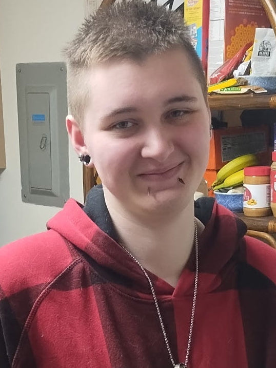 Person smiling in a kitchen
